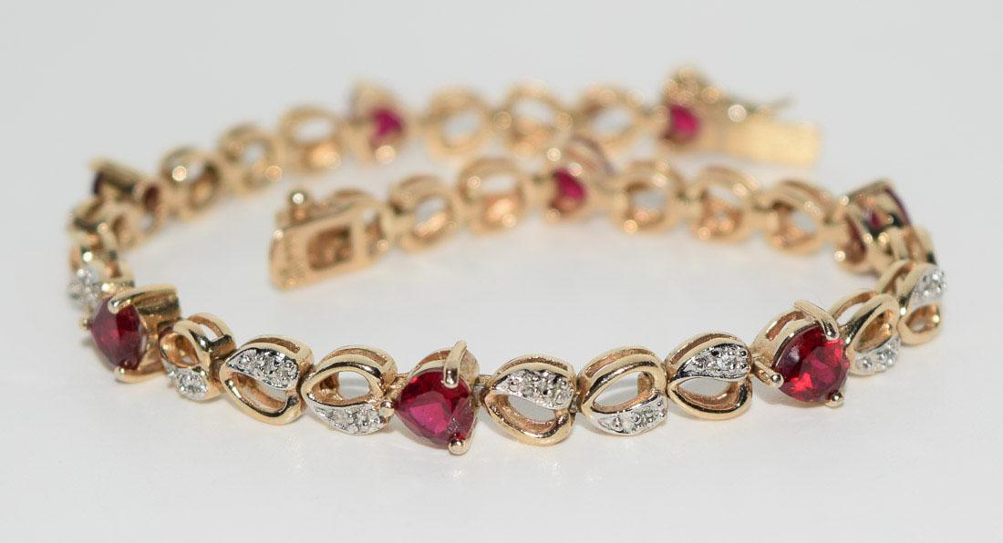 Gold over Sterling Ruby Heart Tennis Bracelet: Weighs 11.6grams Measures approx. 6.3mm wide 7inches long Stamped 925 CZ Tested Ruby