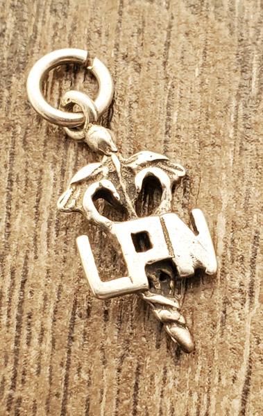 Sterling Silver LPN Charm: Item Details:LPN Charm or Pendant Type: Pendant or Charm Length: 20.5 mm Width: 9.3 mm Other: Stone Type: None Stone Cut: None Stone Color: None Shape/Style: LPN Carats: None Weight in Grams: 1 Hallma