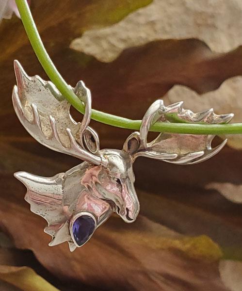 Sterling Silver Moose Pendant: Item Details:Sterling Silver Pendant Type: Pendant Length: 39.2 mm Width: 38.6 mm Other: Stone Type: Amethyst Stone Cut: Pear Stone Color: Purple Shape/Style: Moose Carats: Not Reviewed Weight in Gram