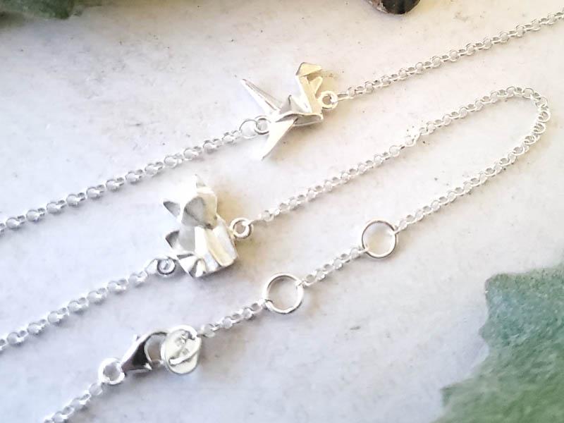 Pair Sterling Silver Bracelets: Item Details:Pair Sterling Silver Bracelets Type: BFF Oragami Bird & Fox Charm Bracelets Length: 6-7.5 Inches Width: 11 mm Other: Lobster Clasp Stone Type: None Stone Cut: N/A Stone Color: N/A Shape/S