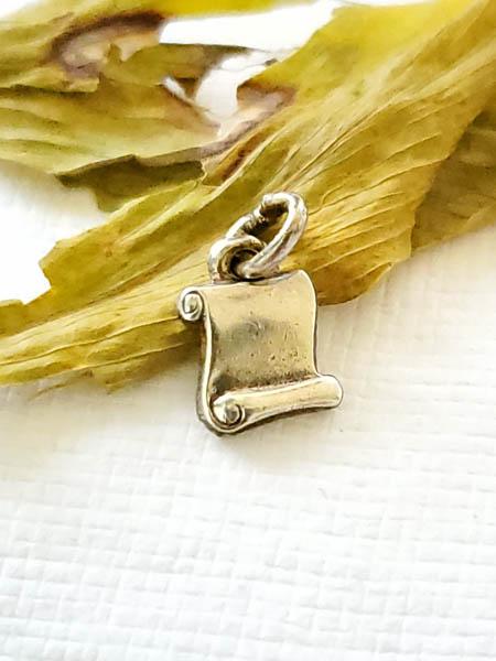 Sterling Silver Charm: Item Details: Small Scroll Paper Measures: 9 x 6.8 mm Other: Vintage Weight in Grams: 0.6 Hallmarks and Stamps: LGB STER Shipping Time: Usually 2-5 Business Days Shipping Rates: Shipping rates start a