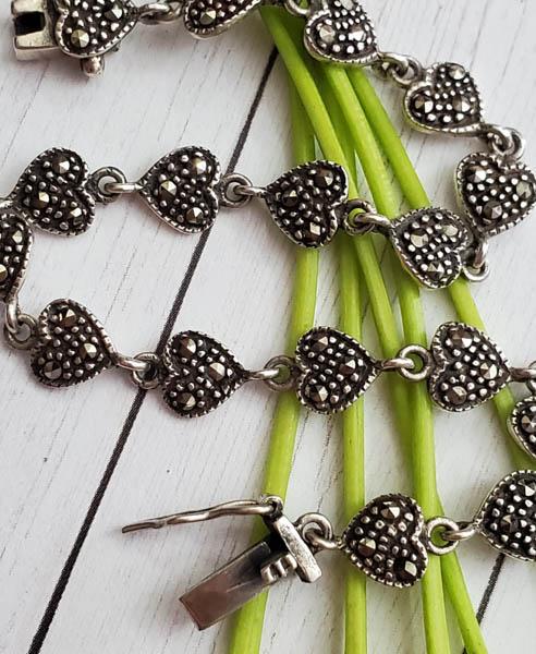Sterling Silver Bracelet: Item Details: Sterling Silver Heart Link Bracelet Length: 7.25 Inches Width: 7 mm Clasp: Box Clasp Stone Type: Marcasite Stone Cut: Round Stone Color: Charcoal Weight in Grams: 7.69 Hallmarks and Stam