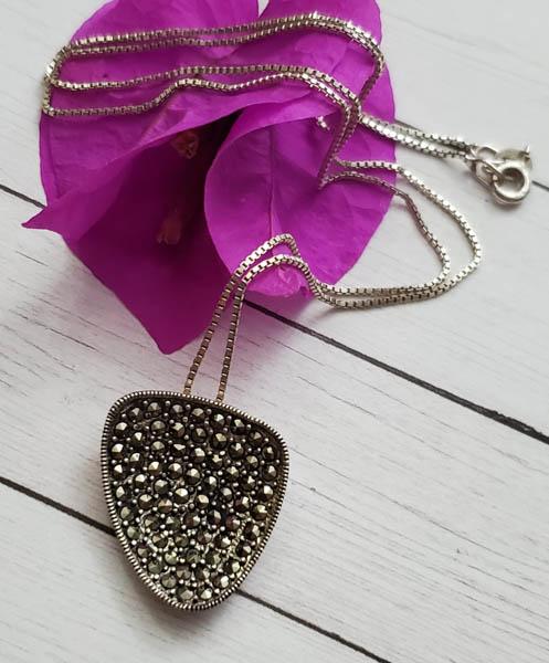 Sterling Silver Necklace: Item Details: Sterling Silver Marcasite Necklace Chain Length: 18 Inches Pendant Drop: 23.5 mm Pendant Width: 20 mm Clasp: Springring Weight in Grams: 5.72 Hallmarks and Stamps: 925, K, Thai Other: Pl