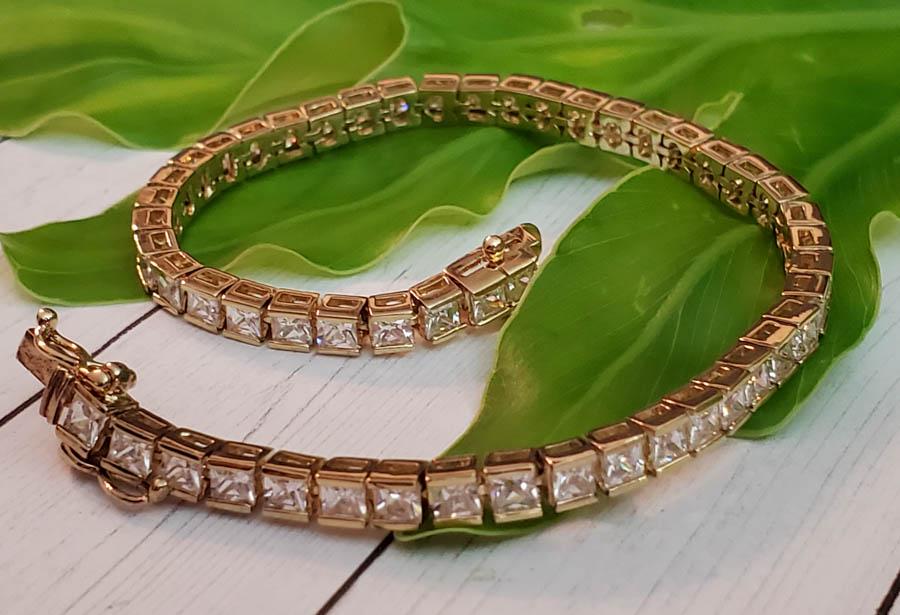Gold Over Sterling Silver Bracelet: Item Details: Gold Over Sterling Silver Tennis Bracelet Length: 7.5 Inches Width: 4 mm Clasp: Box Weight in Grams: 13.5 Hallmarks and Stamps: FAJ, 925, Cz Other: Vermeil Shipping Time: Usually 2-5 Bus
