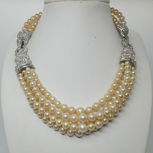1950's Boucher Faux Pearl Collar Necklace: An eye-catching original 1950’s designer costume jewelry collar necklace by the American designer Marcel Boucher. It has five rows of faux pearls strung from two jointed diamante on silver plated je