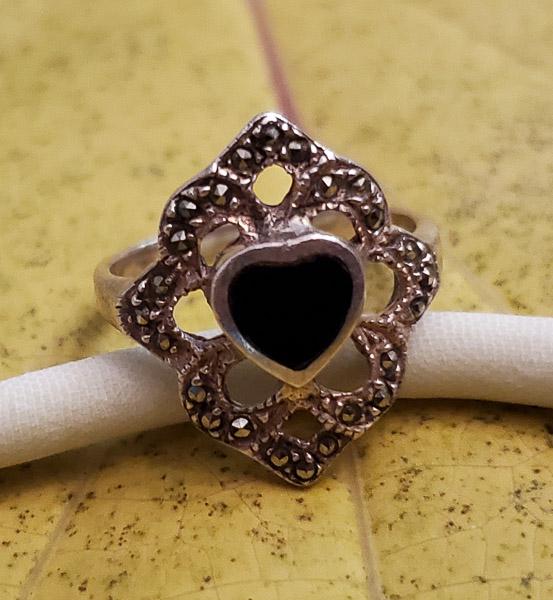 Sterling Silver Marcasite Heart Ring: Item Details: Sterling Silver Marcasite Heart Ring Ring Size: 7 Width if Band Ring: at widest 19.5mm Weight in Grams: 3.42 Hallmarks & Stamps Include: 925, SU Other: Please note: All items are tak
