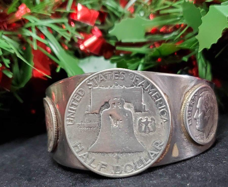 Silver Half Dollar and Dimes Cuff Bracelet: Please see pics for details as this is the exact item you will receive.Ã‚ NOTE: CUFF IS NOT SILVER Size: 2.17 Inches inside diameter Details:Ã‚ Has a Silver Half Dollar and 2 1952 Silver Dimes. 