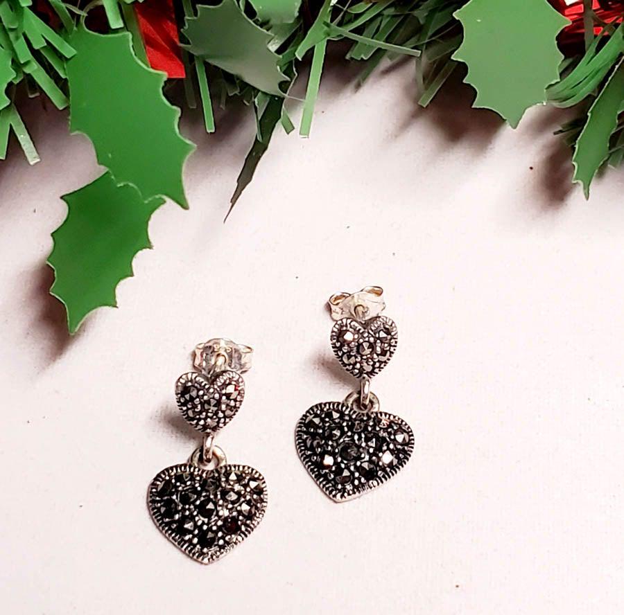 Sterling Silver Marcasite Heart Earrings: Please see pics for details as this is the exact item you will receive. Measures: EarringsÃ‚ have a 20mm drop and are 11.5mm wide Weight in Grams: 2.15 Hallmarks & Stamps Include: 925, Thai Ple