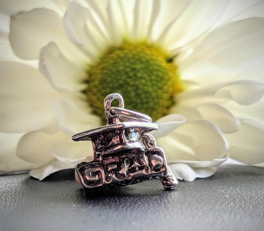 Sterling Silver Graduate Charm: Item Details: Sterling Silver Graduate Charm Measures: 13x13.8 mm Weight in Grams: 3 Hallmarks and Stamps: 925 Please Note: All items are taken at stamped value and are not tested unless stated. As wi