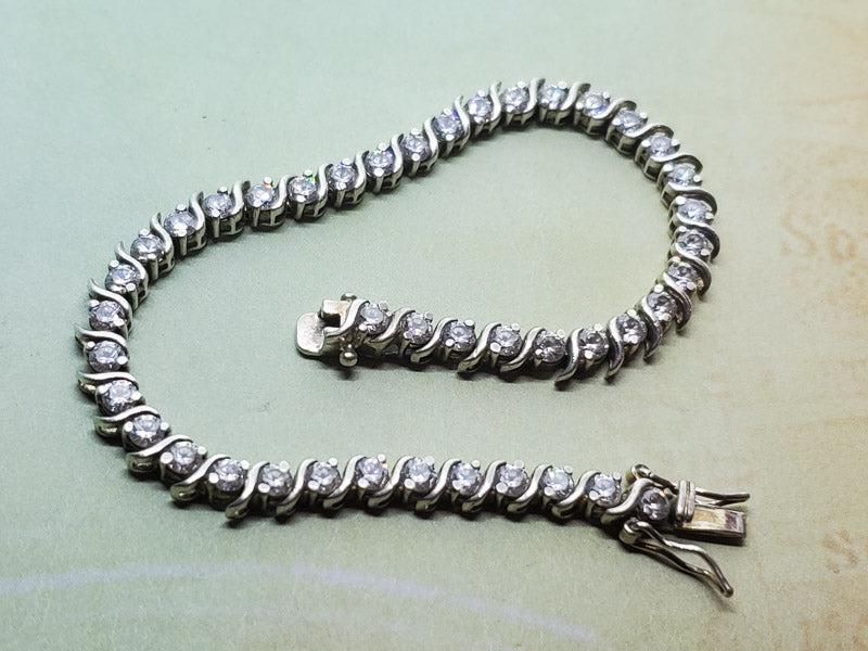 Sterling Silver Tennis Bracelet: Please see pics for details as this is the exact item you will receive.Ã‚ Length: 7 inchesÃ‚ Weight in Grams: 10.88 Hallmarks and Stamps: 925 Due to the limited amounts of cleaning and polishing