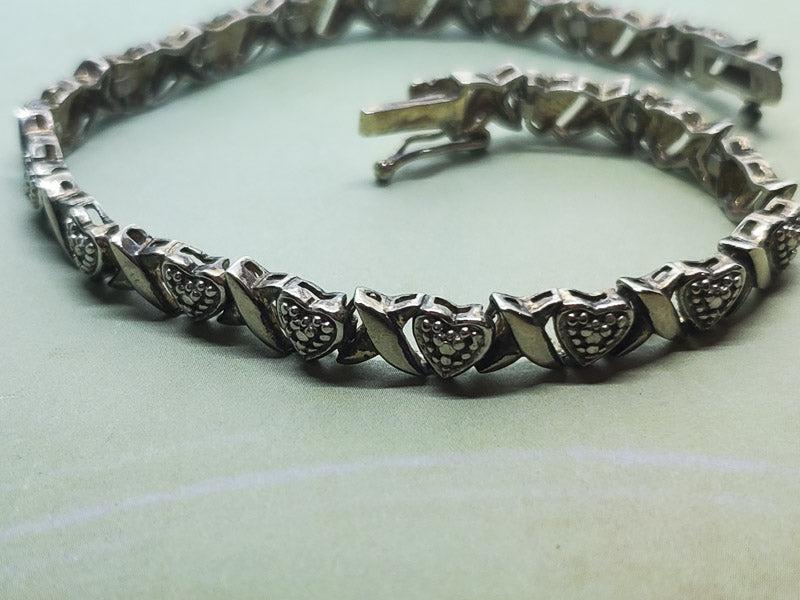 Sterling Silver Diamond Heart Tennis Bracelet: Please see pics for details as this is the exact item you will receive.Ã‚ Length: 7.5 inchesÃ‚ Weight in Grams: 12.5 Hallmarks and Stamps: 925,FAS Due to the limited amounts of cleaning and poli