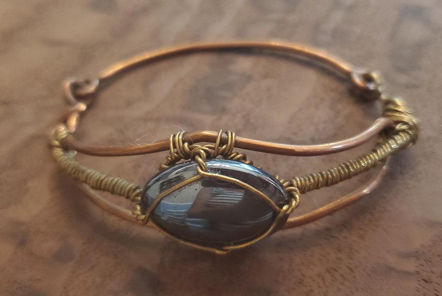 Wire Wrapped Hematite and Copper Bracelet: Please see pics for details as this is the exact item you will receive.Ã‚ Length: 2.5 inches inside Width: Appx 24.5mm wide Hallmarks and Stamps: N/A Due to the limited amounts of cleaning and poli