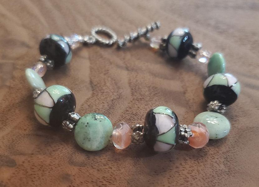 Lampworks Glass Bracelet: Please see pics for details as this is the exact item you will receive.Ã‚ Length: 8 inches Width: 13 to 14 mm glass beads Hallmarks and Stamps: N/A Toggle Clasp Due to the limited amounts of cleani