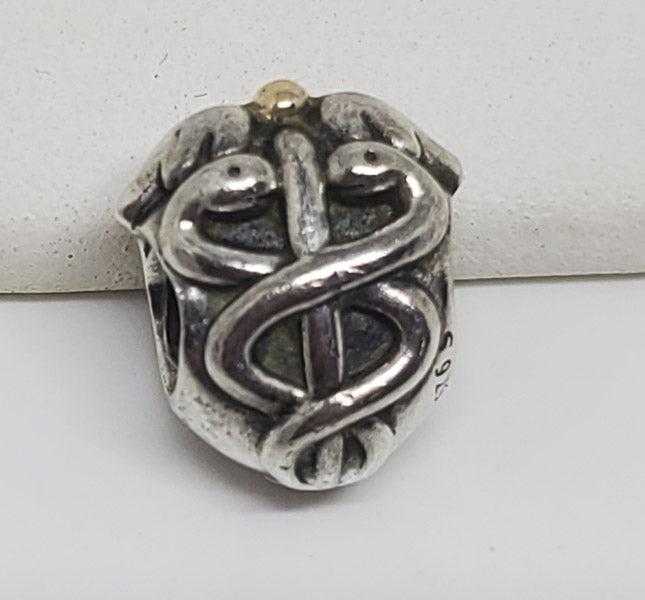 Pandora Sterling and 14k Medical Charm: Please see the pictures for exact details as this is the item you will receive.Ã‚ Measurements: 11.5mm by 10mmÃ‚ Weight in Grams: 3.46 Hallmarks and Stamps: ALE, 925 Other: Caduceus Charm Due to