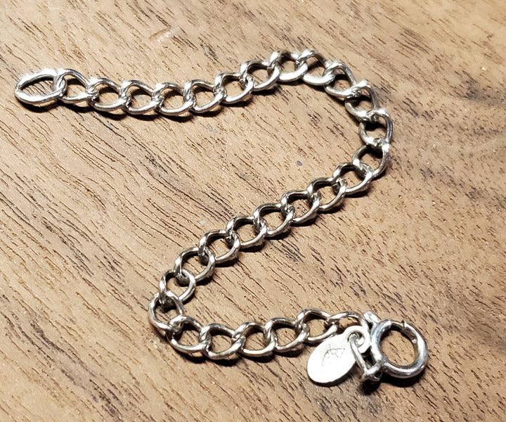 Signed Child's Sterling Silver Charm Bracelet: Please see pics for details as this is the exact item you will receive.Ã‚ Length: 4.5 inches and 4mm wide Weight in Grams: 2.45 Hallmarks and Stamps: 925 Due to the limited amounts of cleaning and 