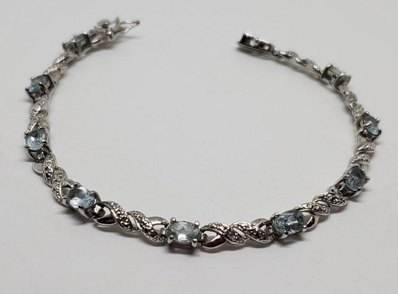 Sterling Silver Topaz Tennis Style Bracelet: Please see pics for details as this is the exact item you will receive.Ã‚ Length: 7.5 inches, 4.5mm wide Weight in Grams: 8.83 Hallmarks and Stamps: 925 Due to the limited amounts of cleaning and