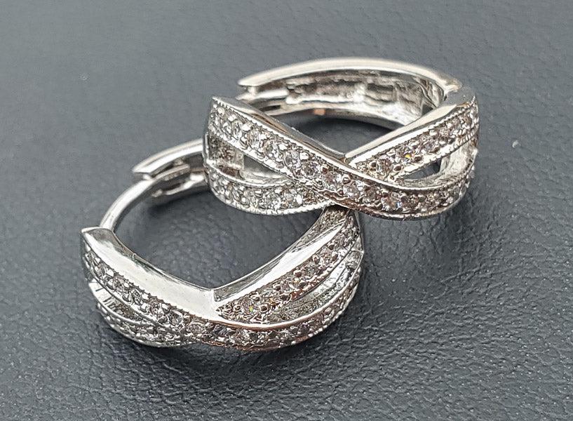 Silver Tone Huggie Earrings: Please see pics for details as this is the exact item you will receive.Ã‚ Measures: These have a 15mm drop and are 5.8mm wide Weight in Grams: 3.4 Hallmarks & Stamps Include: None Due to the li
