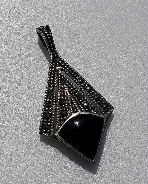 HAN Sterling Silver Marcasite and Onyx Pendant: Please see pics for details as this is the exact item you will receive.Ã‚ Measures: 34.3mm drop and 18mm wide Weight in Grams: 3.25 Hallmarks & Stamps Include: 925, Thai, HAN Please note: All i