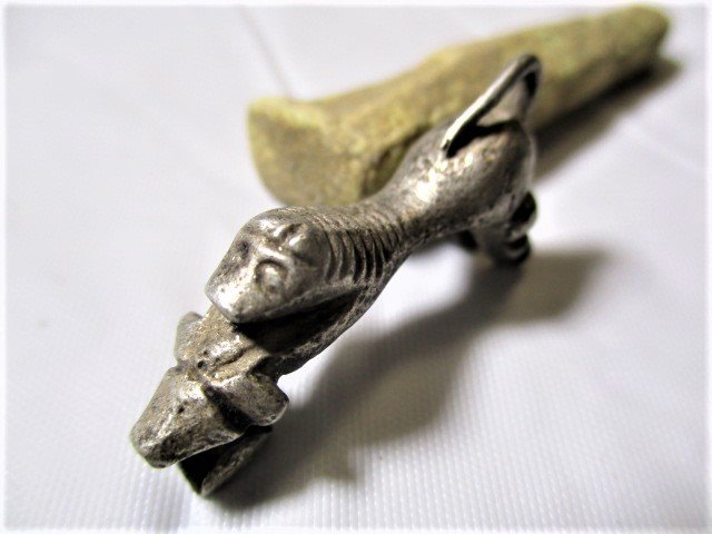 600 AD Roman, Silver Lion Fibula brooch: 600 AD Roman, Silver Lion Fibula Brooch A fibula is a brooch or pin for fastening garments, typically at the right shoulder. The fibula developed in a variety of shapes, but all were based on the safe