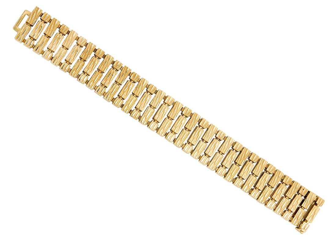 A Gold Bracelet, Lucas: The flexible broad strap composed of textured brick linking, mounted in polished and matte 18k gold, length 6 1/2 inches