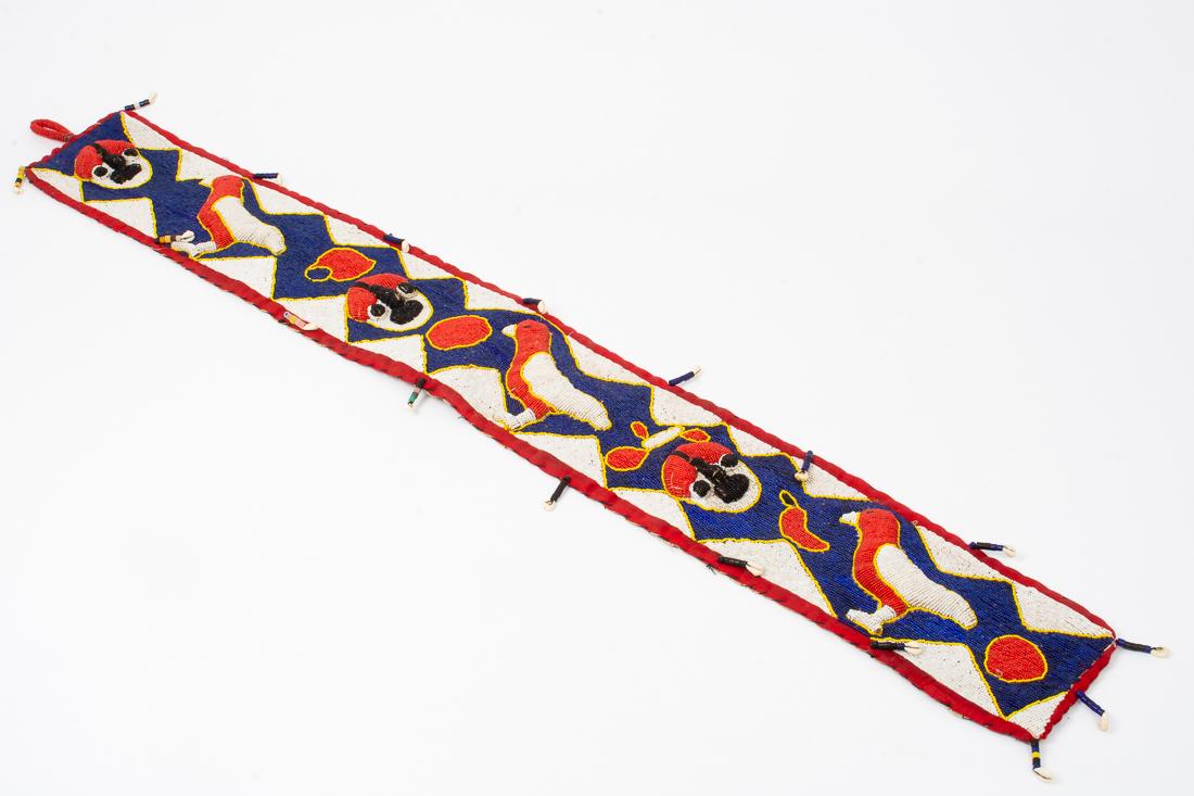 African Belt Yoruba Sash from Nigeria Cowrie Shells 51": Description: Diviner belt / Yoruba sash with decorative woven beads and cowrie shells, with people, birds and patterns in red, yellow, blue, white and black from Nigeria, Africa.