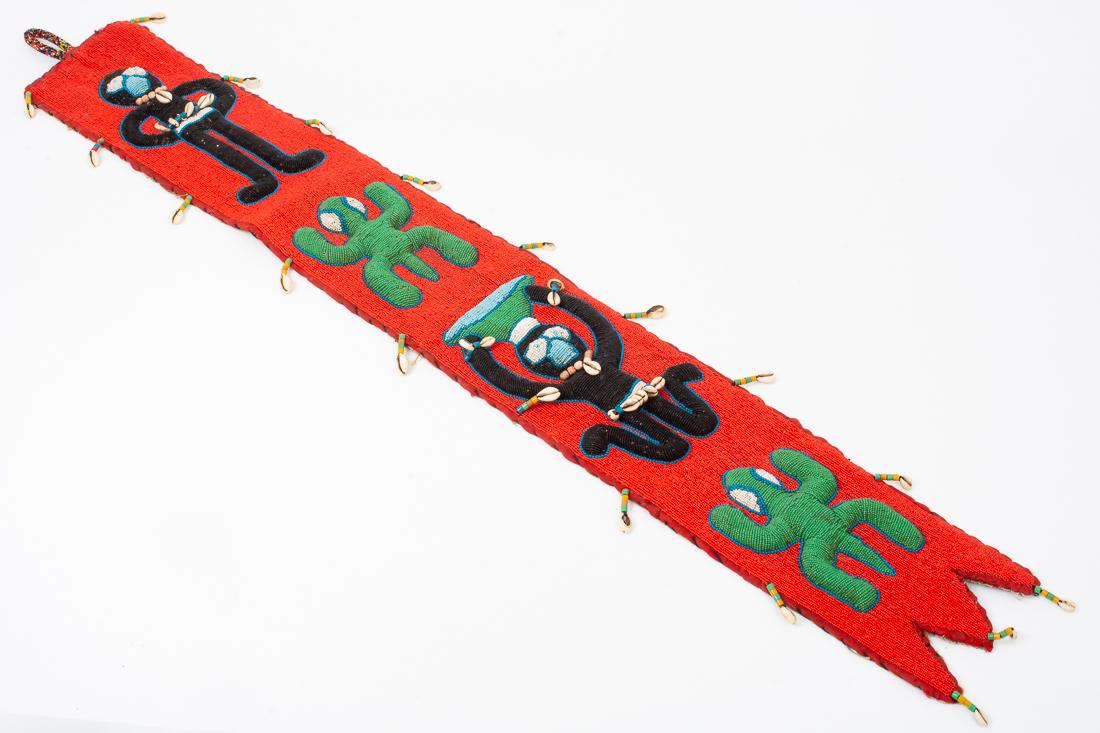African Diviner Yoruba Sash from Nigeria 52": Description: Diviner belt / Yoruba sash with decorative woven beads and cowrie shells, with people and lizards in blue, green, red, white and black from Nigeria, Africa. Dime