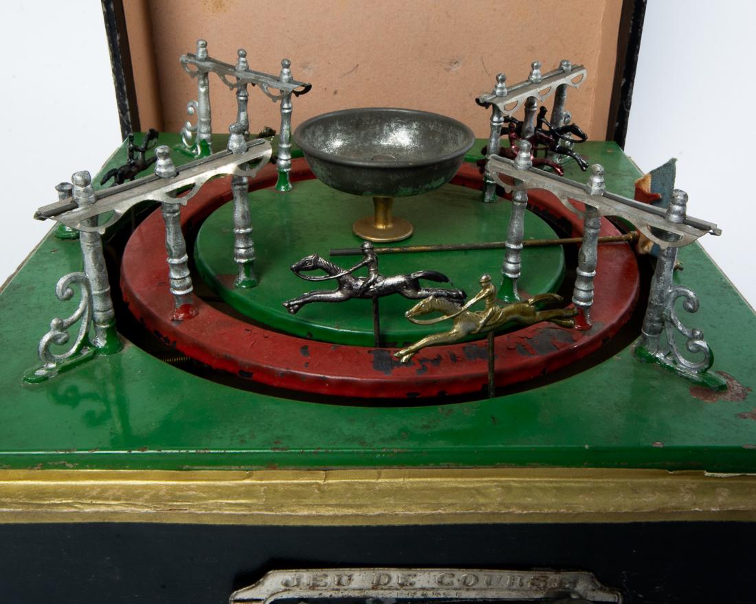 Antique (c. 1880s) Jeu de Coruse Horse Racing Game 10": Antique (c. 1880s) Jeu de Coruse Horse Racing Game Antique game in fully functional order -- springs work and horses move quickly around a loop. Dimensions: 10.5" x 10.5" x 5.5" Estimated Domestic Shi