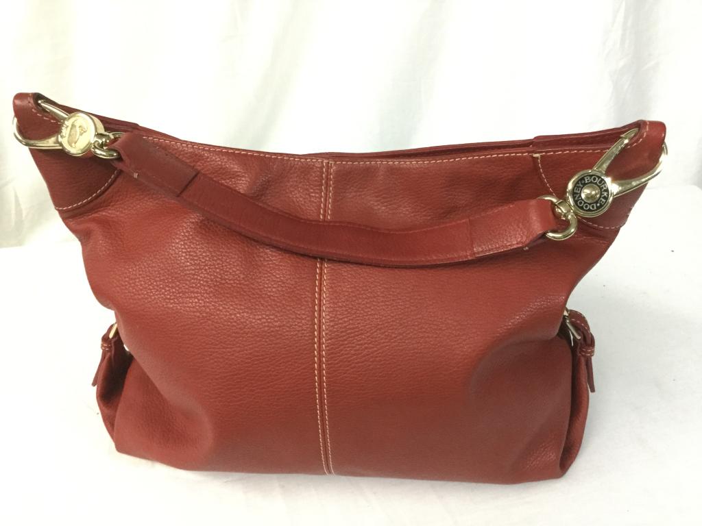 Dooney & Bourke Bag: Nice Hobo bag with vibrant red color. Bag is in great shape with no tears or rips. Has s/n tag inside bag.