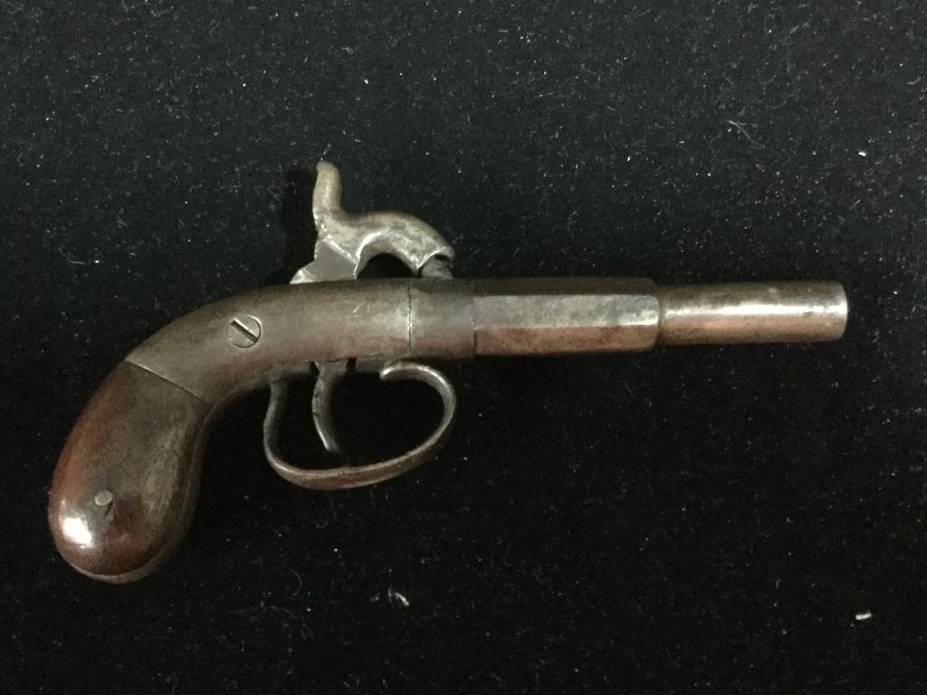 Very Early Derringer: Early black powder Derringer. No marks, we believe it might be 32 cal. Neat little piece. Measures 6 1/2".