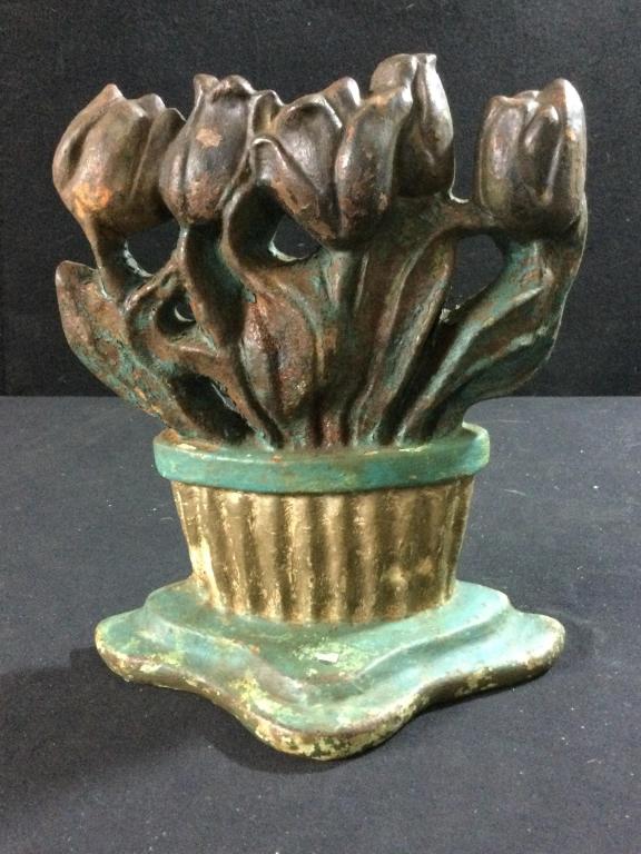 Antique Cast Iron Door Stop: Very heavy piece that measures 8" h x 7"l x. Condition is consistent with age with some wear on the paint. Nice flowers & pot door stop. Charming.
