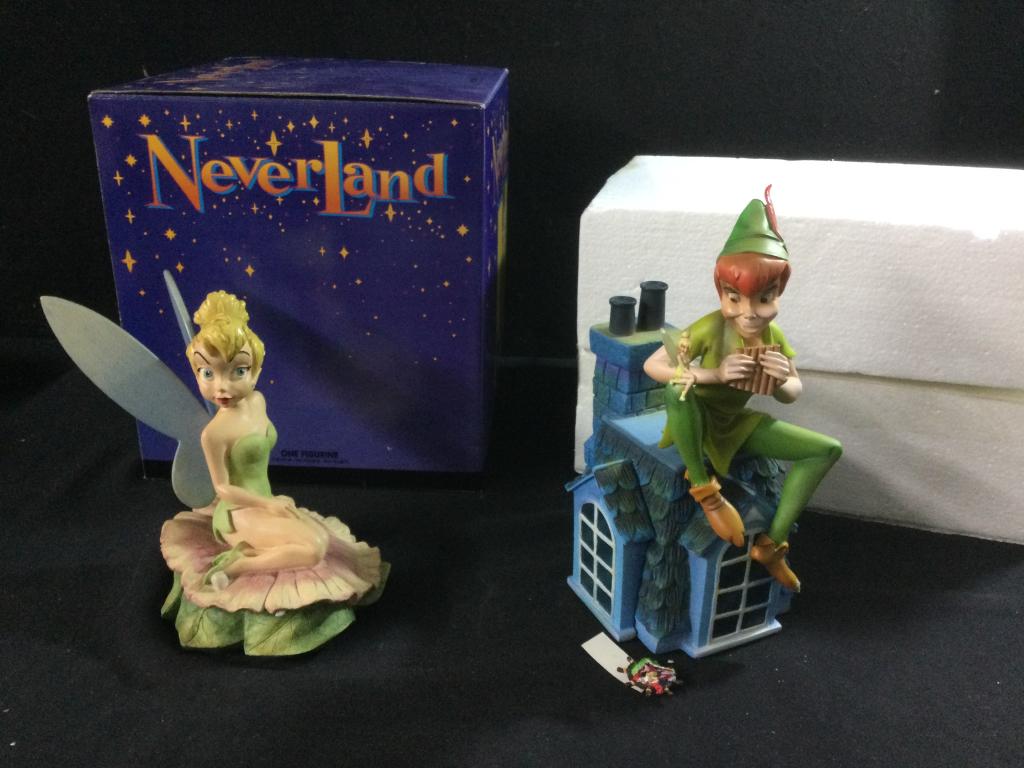 The Art of Disney Statues: One is Peter Pan sitting on top of house playing music w/Tinkerbell seating on his knee. It is marked on bottom " A Song for a Pixie" LE1000. Measures 9 1/2"h x 5"w. The other piece is Tinkerbell with