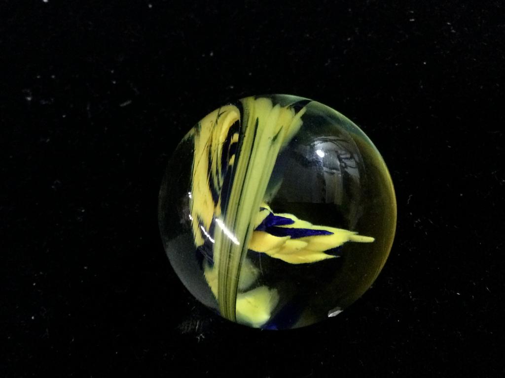 Hand Blown Signed Glass Marble: Nice yellow & blue swirl. Measures 5 1/4" around. In good condition with no chips or cracks. Measures 5 1/4" all around.