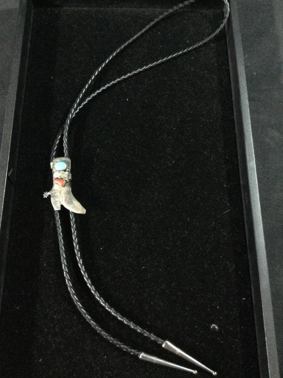 Navajo Silver Bolo: Neat piece marked on back of a cowboy boot w/spur. Has turquoise & coral. Measures 2"h x 1 1/4"w. In good condition.