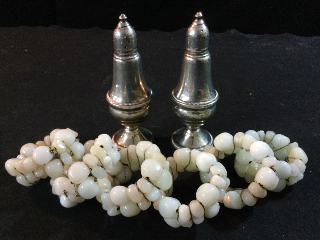Gemstone & Sterling Lot: Sterling S&P shakers that weigh 269.8 with weighted bottoms. Measure 5"h & in good condition. There is 6 vintage gemstone napkin rings. In good condition.