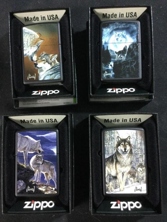 Zippo Lighters: Total of 4 in original boxes. They all have wolves on them & signed Al Agnew. All in new condition.
