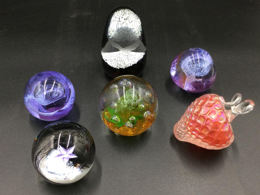 Paperweights: Total of 6 paperweights in this lot. Four are marked Caitness Scotland. (Fleur, Tango, mooncrystal & pebble). No chips or cracks. Value 125.00-250.00