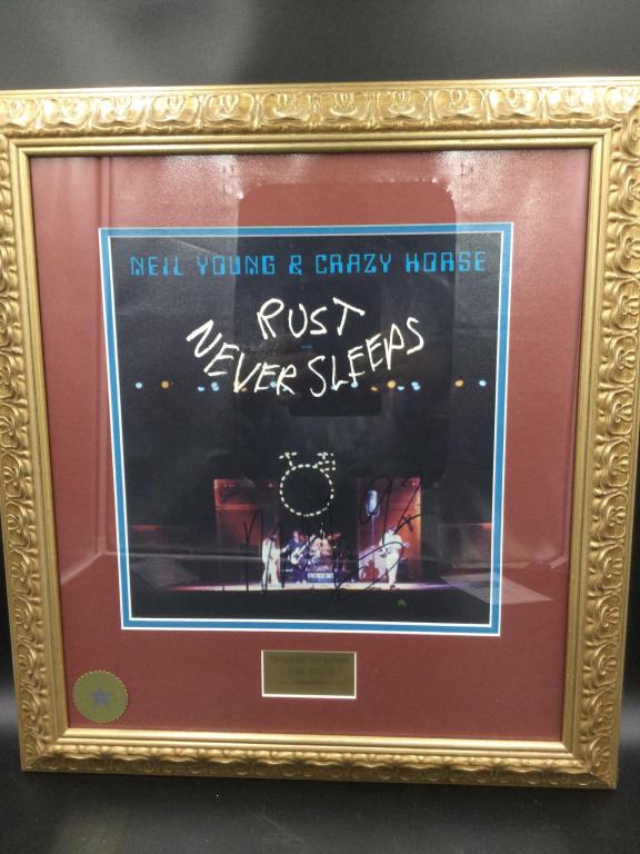 Neil Young & Crazy Horse Rust Never Sleeps Signed: Autograph by Neil Young and has Seal on Front & back. Frame measures 21 1/4"hx 19 1/4"w. Has Guarantee of Authenticity on back by Walt Disney World Co. See pictures.