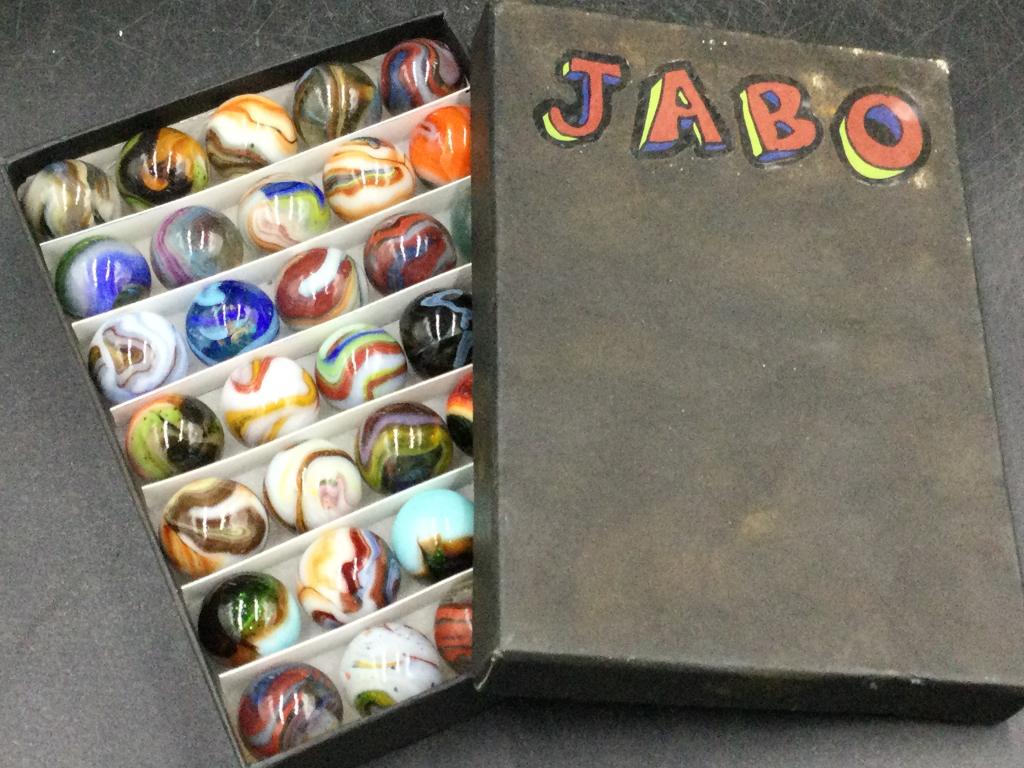 JABO Marbles: Comes in collector box. Neat set with JABO on cover of box. See pictures. There is total of 37 marbles in this lot. Please read terms of sale, no refunds given.