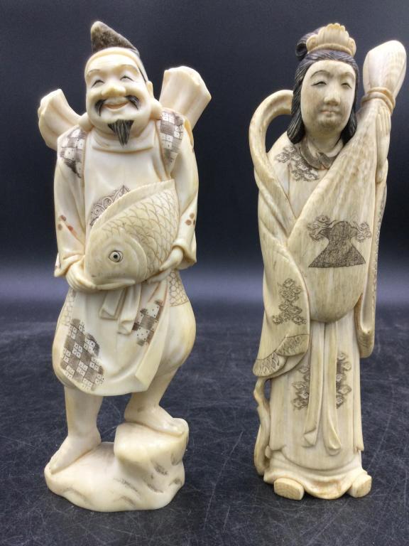 Vintage Carved Statues: Both early pieces are signed and good condition. Neat carving of a man holding fish wrapped around his middle 6"h. The other piece is a lady holding a bag/basket. 6 1/4"h. Please see our terms of sale