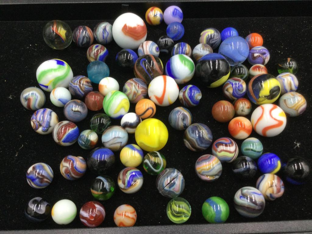 Marbles: Total of 86 marbles, including Javas. There is 10 larger ones (shooters). Condition is consistent with age and use. Neat swirls and various colors. Some marbles have imperfections on them. Please read