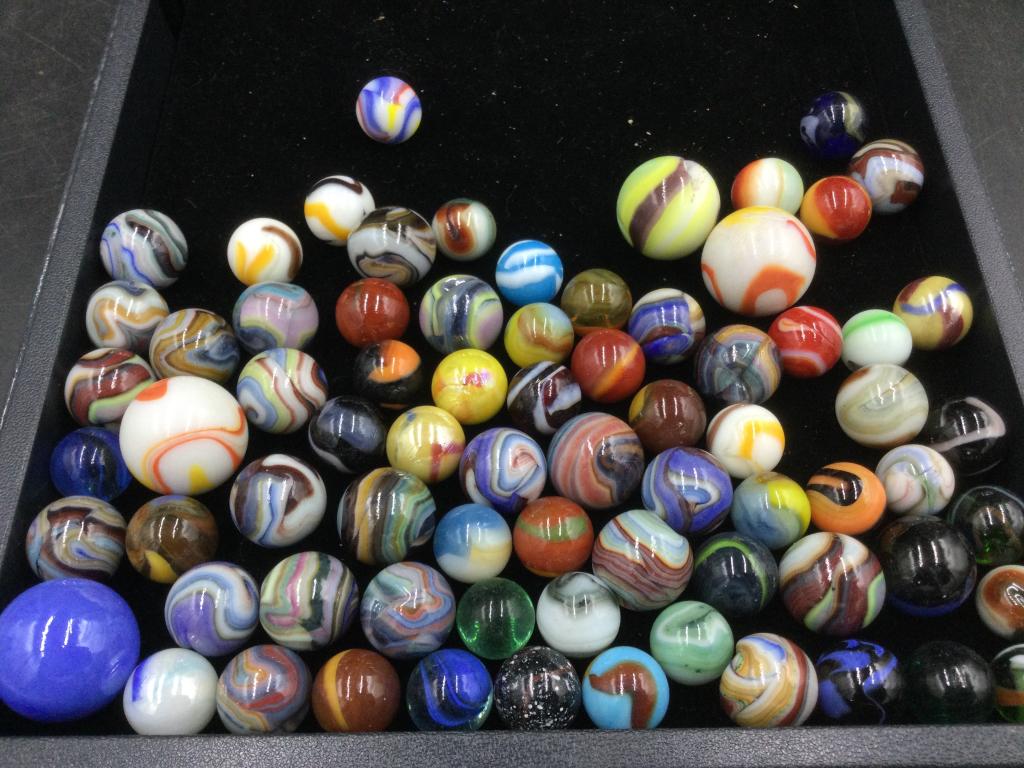 Marbles: 84 marbles in this lot. Vibrant colors with orange on some of the marbles. See pictures this is a good one. Some marbles have imperfections. Please read our terms of sale, no refunds given.