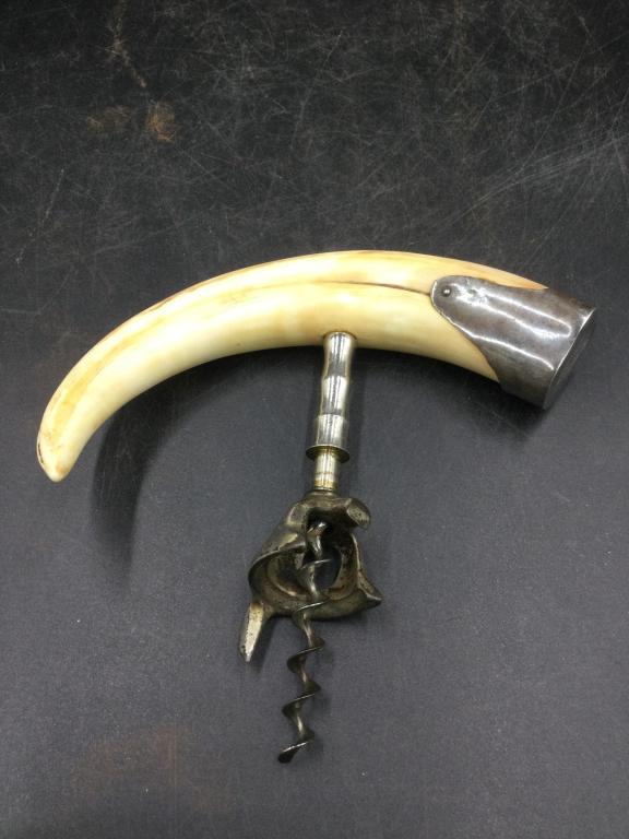 War Hog Wine Opener: Neat piece that has a war hog tusk as holder attached with cork screw. Tusk measures 6". See pictures. Please read our terms of sale, no refunds given.