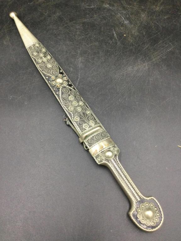 Dagger: Neat piece that is in embellished silver sheath. Measures overall 17" in sheath. Not sure of age. See pictures, condition is good. No refunds given.