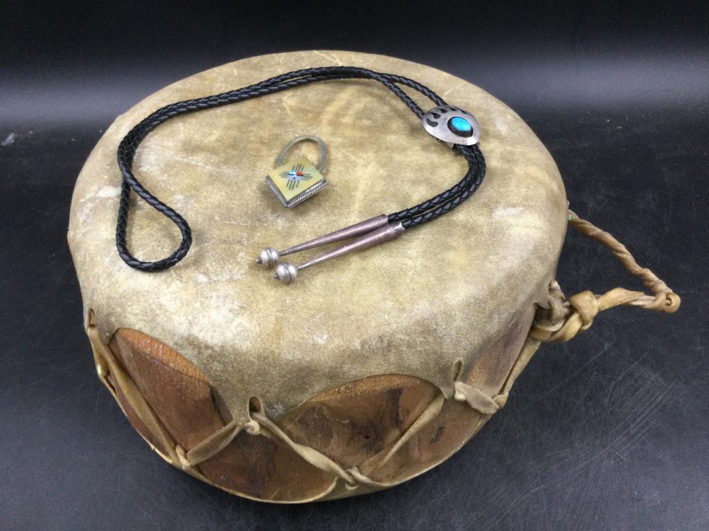 Indian Lot: In this lot is a Navajo bolo with sterling & turquoise. Also a Zuni keychain sterling piece. The last piece is a drum, measures 9" x 5". See pictures, this is a cool lot. Condition is good. No refunds
