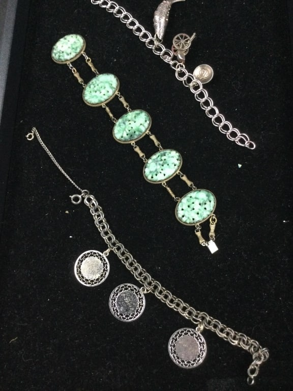 Sterling Bracelets: Total of 3 bracelets. There is 2 charms bracelets 6.5" and 7". The other bracelet is a vintage carved jadeite jade copper bracelet 7. 1/4" (needs hook fixed). See pictures. No refunds given.