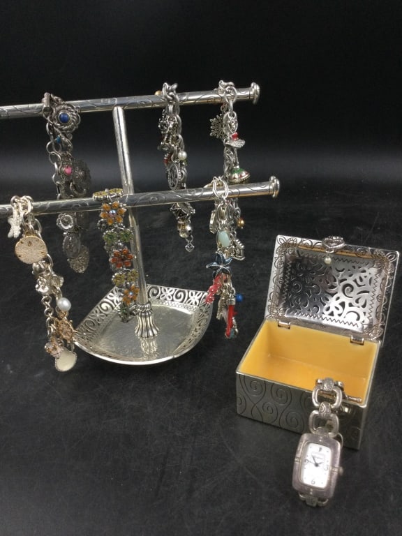 Brighton Lot: In this lot is a Brighton jewelry holder with 6 charm bracelets. There is also a Brighton box with watch. Condition is good, see pictures. No refunds given.