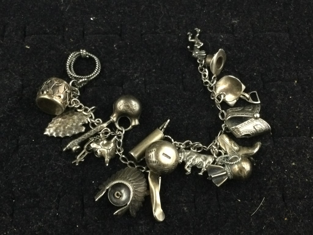 Sterling Indian Charm Bracelet: Charm bracelet with full Indian charms. Estimate 16 charms on this bracelet.. Condition is good, see pictures. No refunds given.