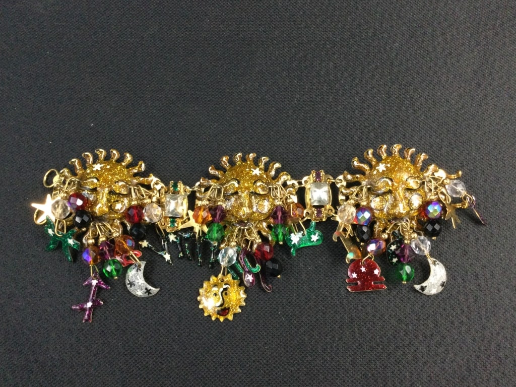 Lunch at the Ritz Bracelet: Another great piece with sun appears to be sleeping with moons, etc. See pictures. Measures about 8" and suns are almost 2". No refunds given.