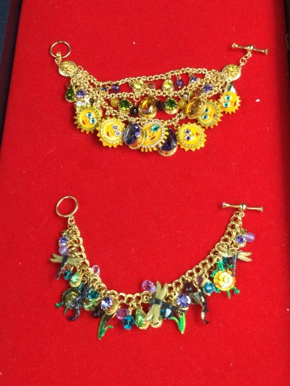 Lunch at the Ritz Charm Bracelets: Total of 2 in this lot. Both have rhinestone and crystals. There is a sun charm bracelet and the other has dragonflys, turtles, lizards. Both are in good condition see pictures. No refunds given.