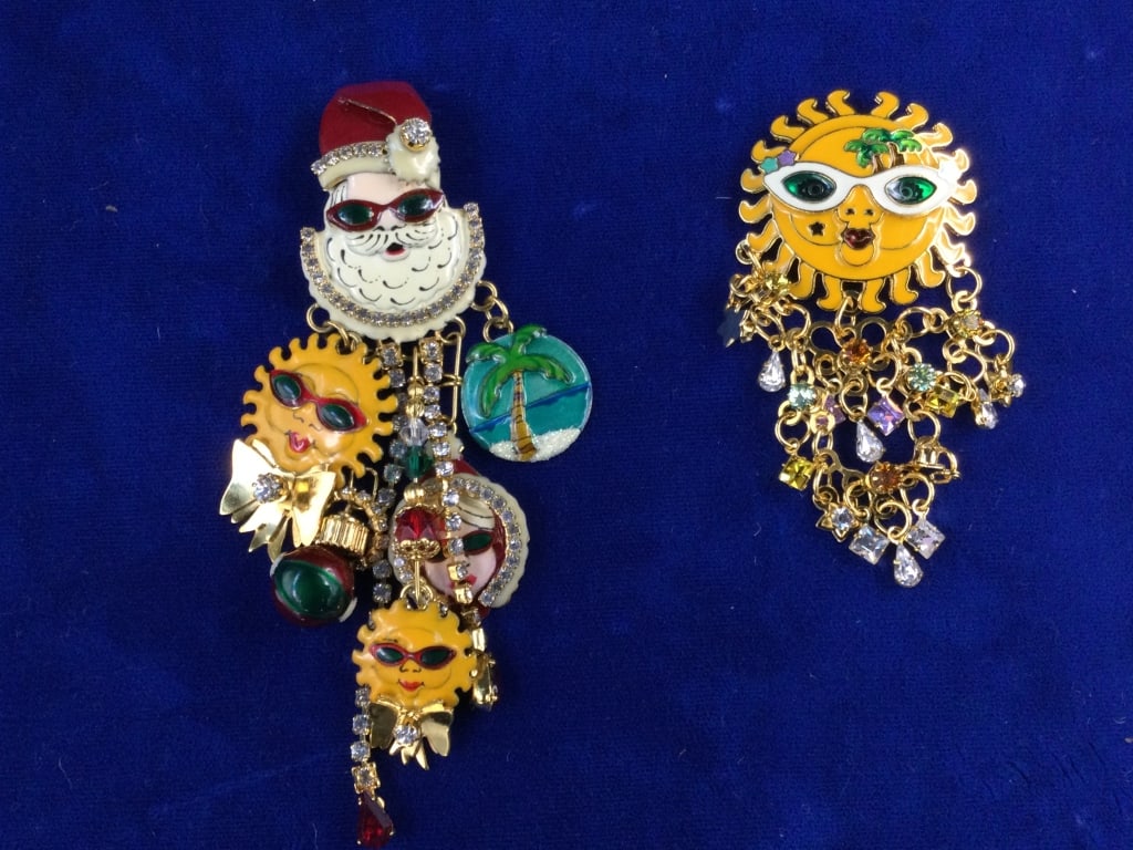 Lunch at the Ritz Pin/Pendant: Total of 2 in this lot. One is a sun w/palm trees (3"). The other is Santa (4.5") with palm trees, suns and Ms. Claus. All have enamel, rhinestones and crystals. See pictures, condition is good. No re